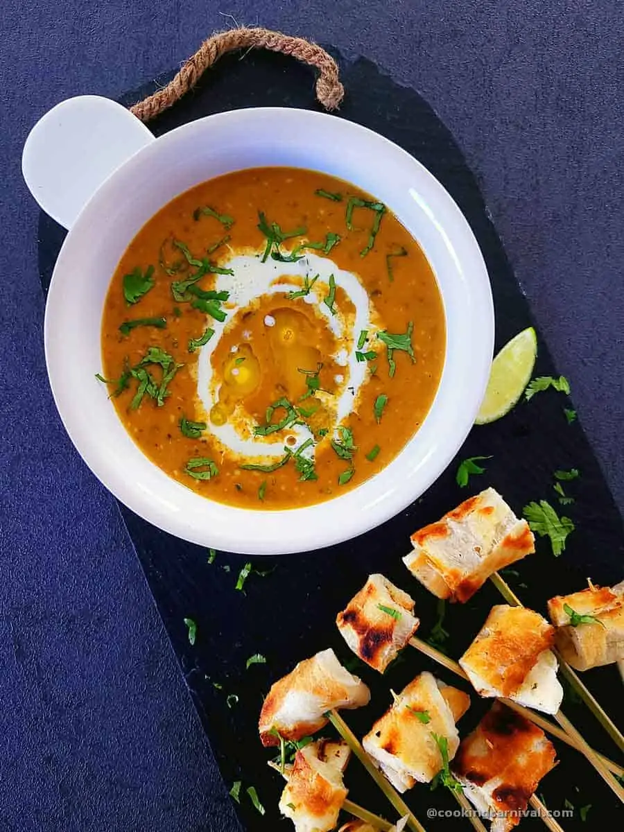 Dal Makhani fondue in a bowl with garlic naan