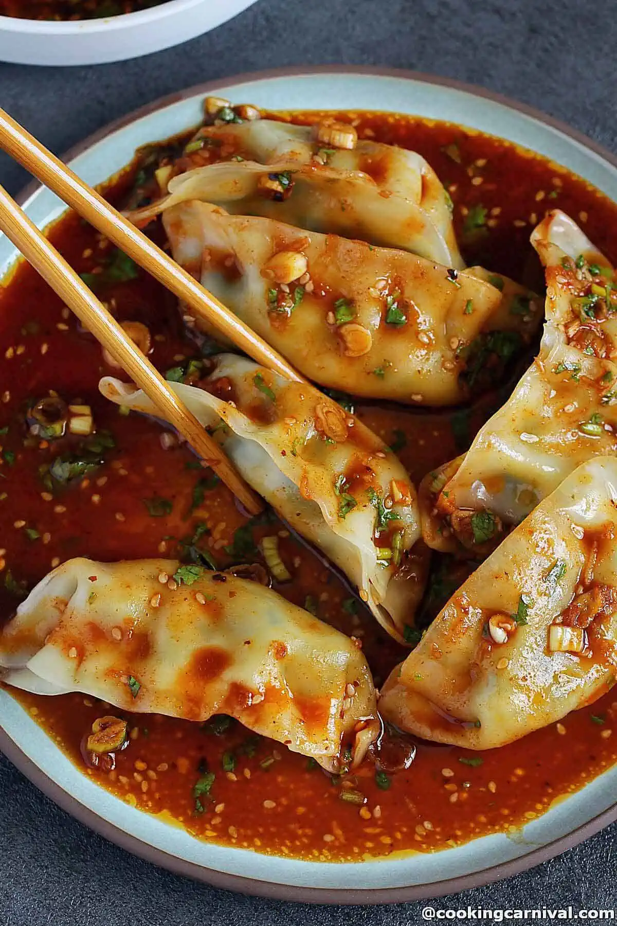 Dipping Dumplings in a sauce. 