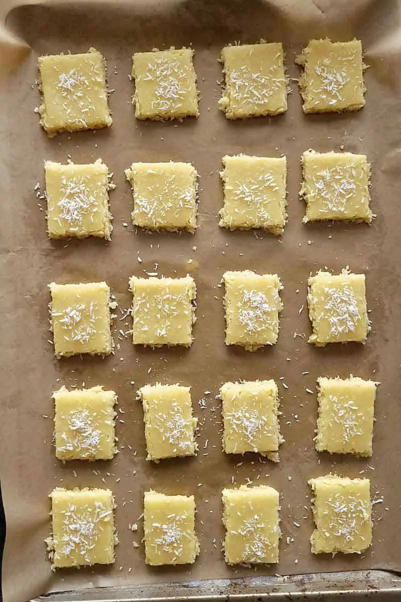 coconut cookies on a parchment paper lined baking tray