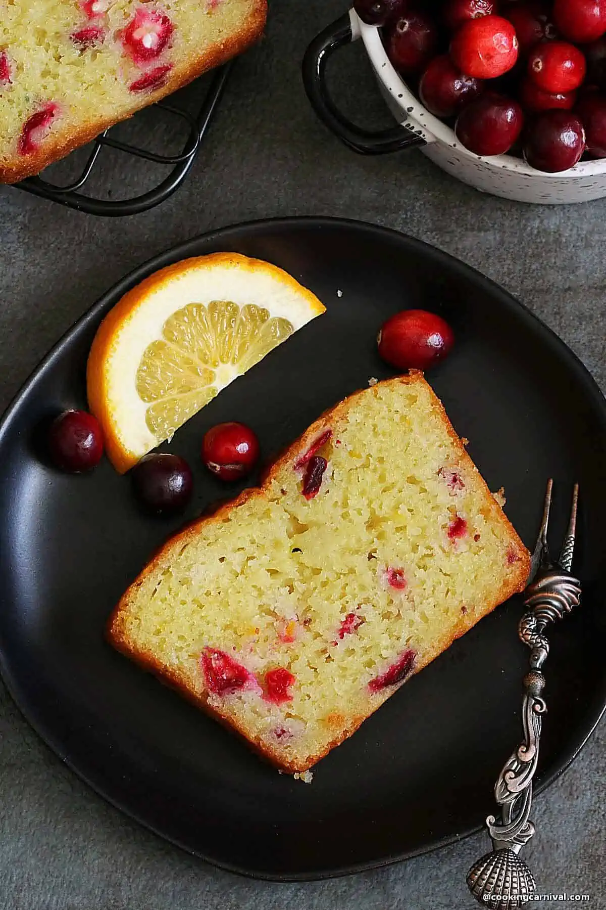 slice of a orange cranberry bread in a plate.