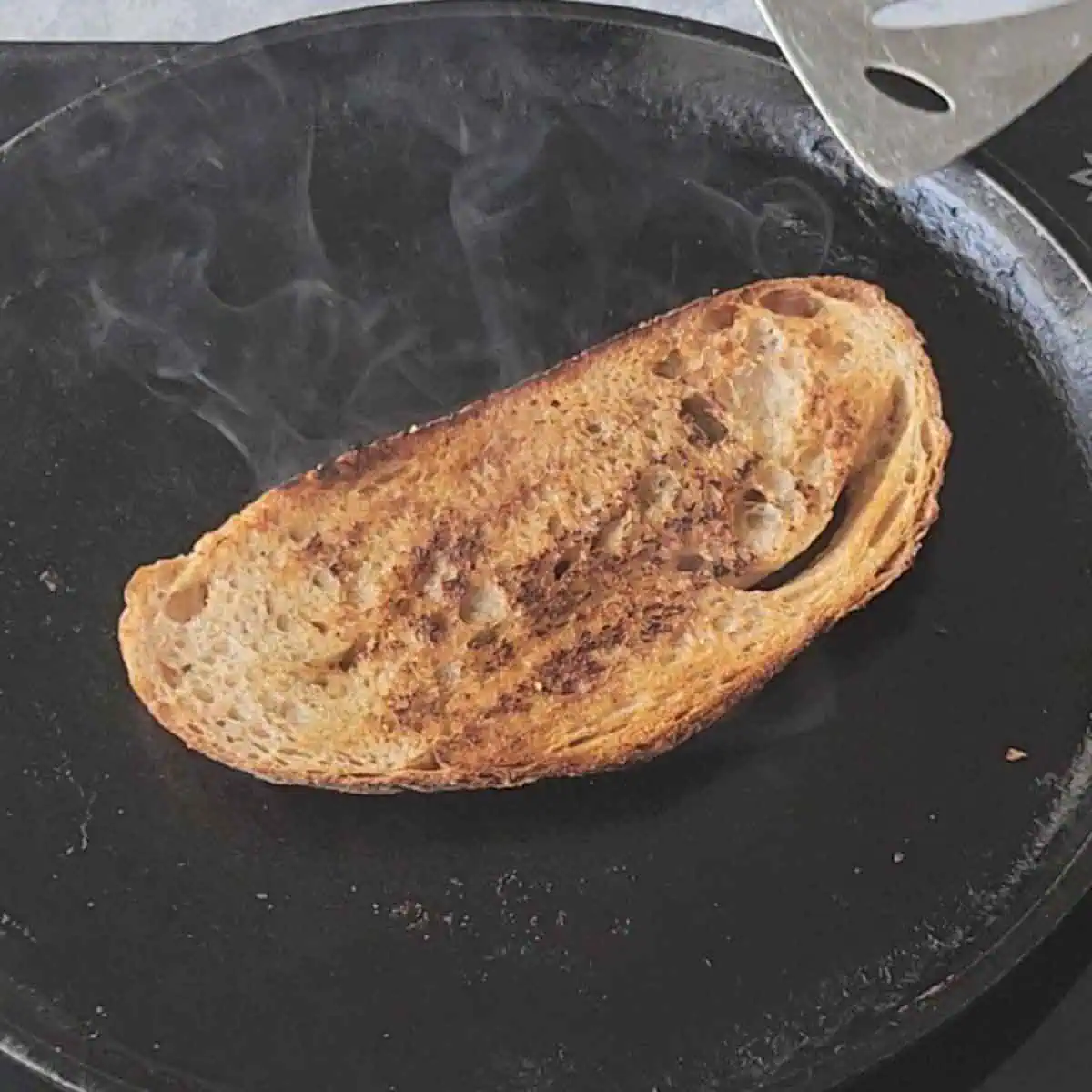 toasted slice of sourdough bread on a griddle. 