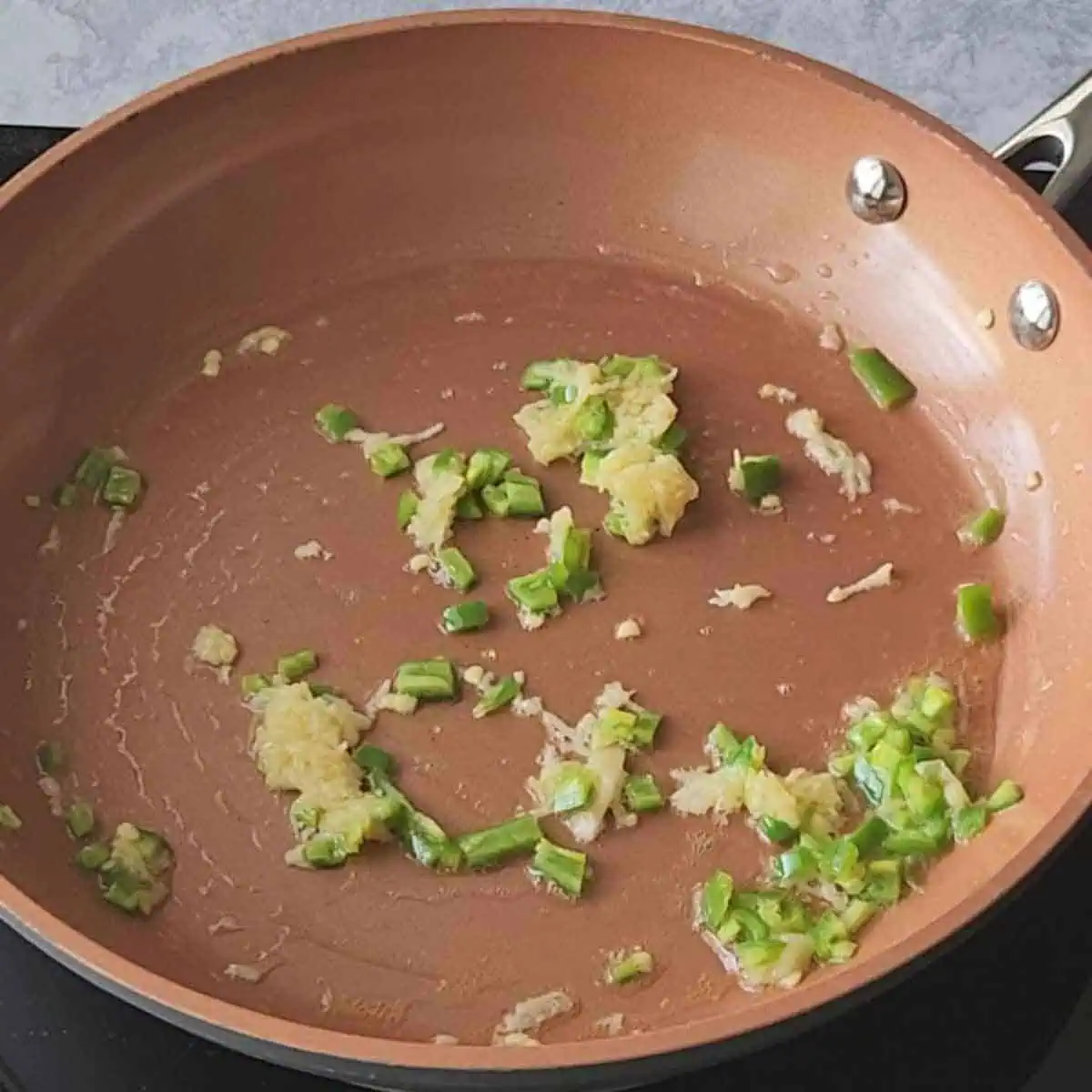 Sauteing garlic and jalapenos in butter.