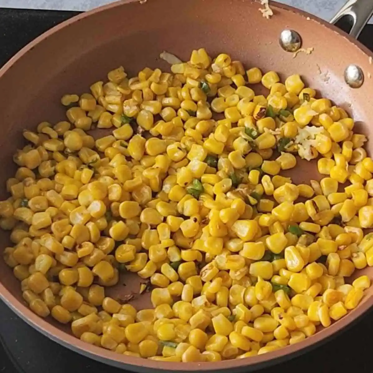 adding corn in sauteed garlic and jalapenos and cooking it until caramelized. 