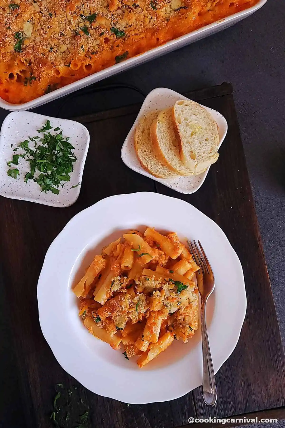 olive garden copy cat Five Cheese Ziti al Forno in a white plate, crusty bread on the side.