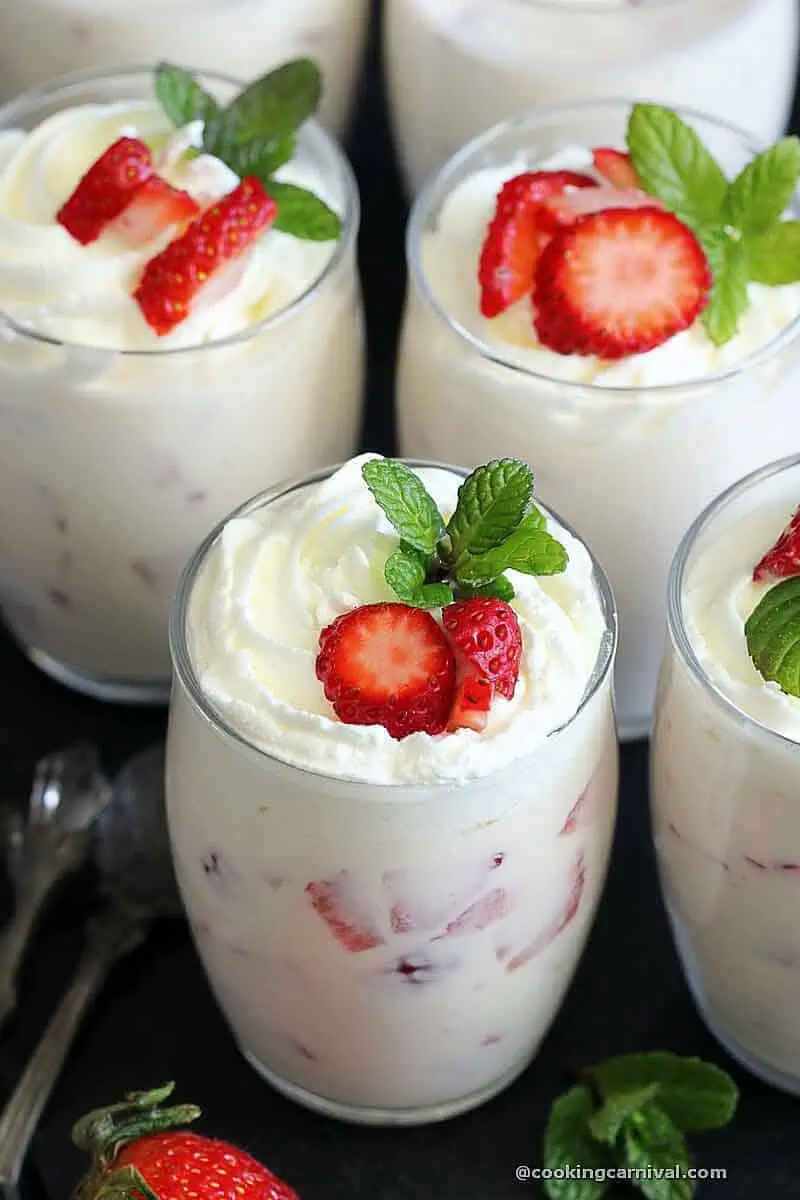 Fresas con Crema in 3 cups garnished with whipped cream and strawberries