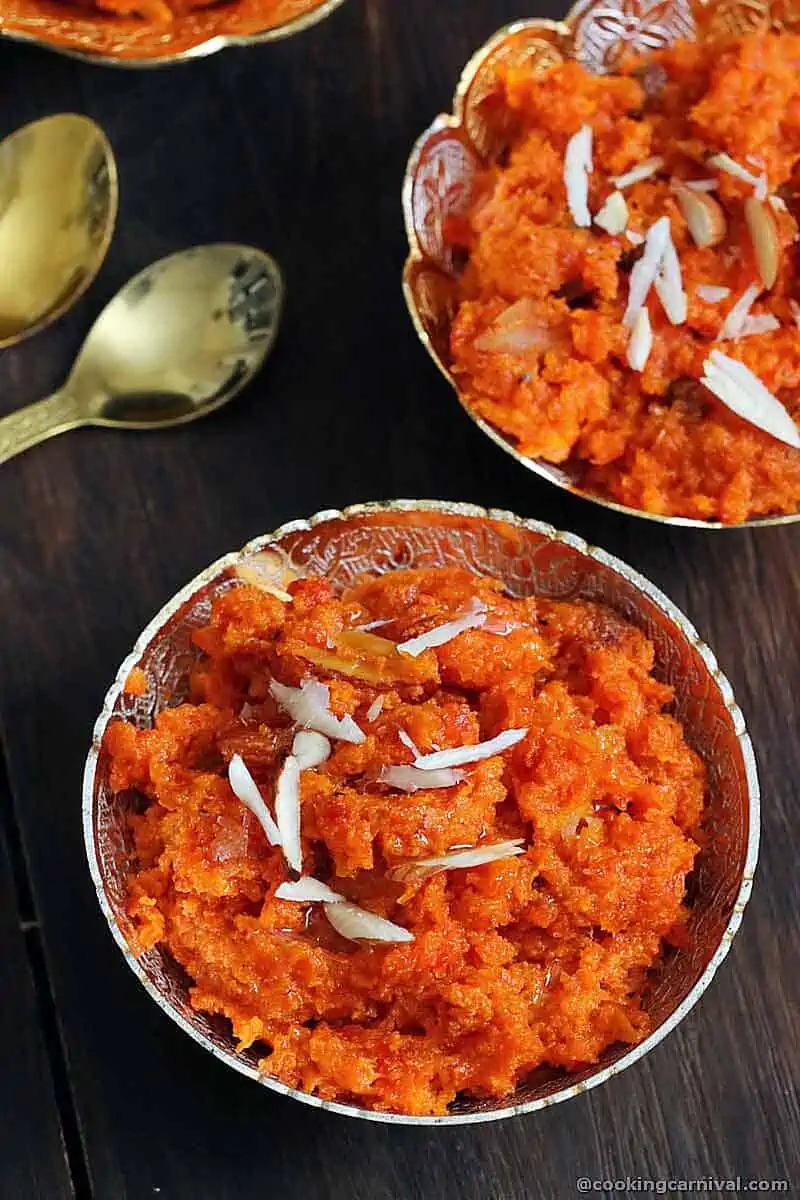 carrot halwa in a bowl, garnished with almonds