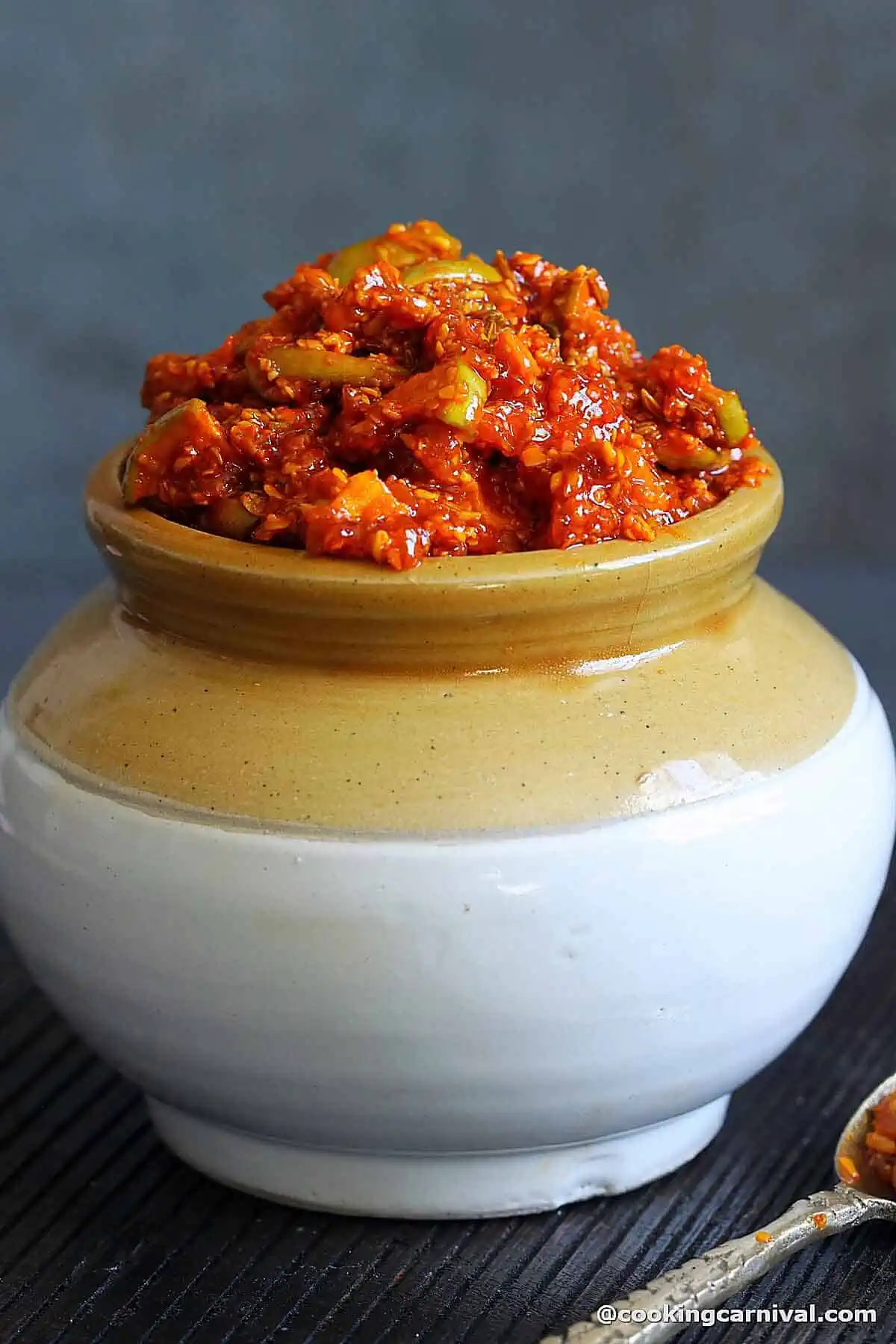 green apple pickle in a traditional Indian Jar.