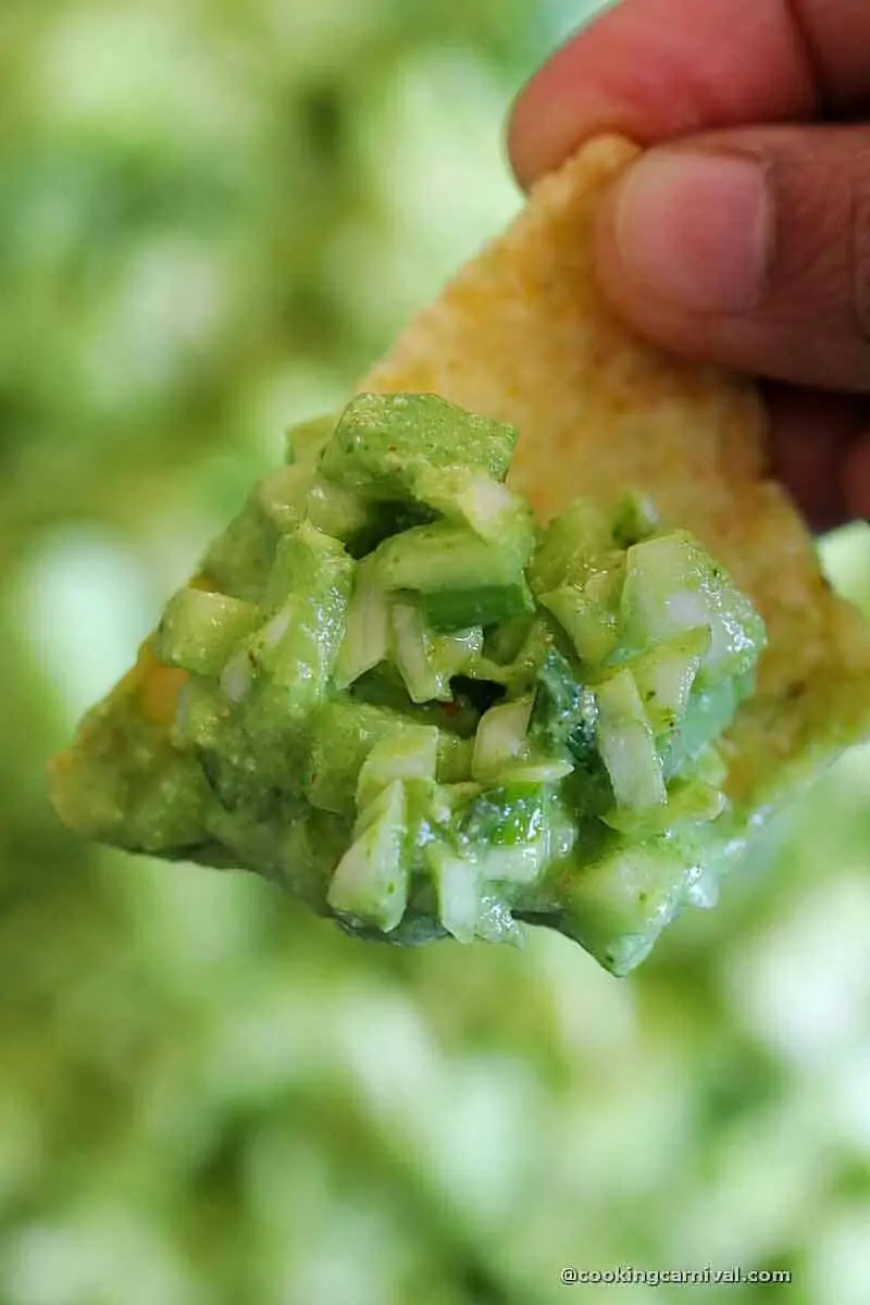 Scooping Green Goddess salad with tortilla chips