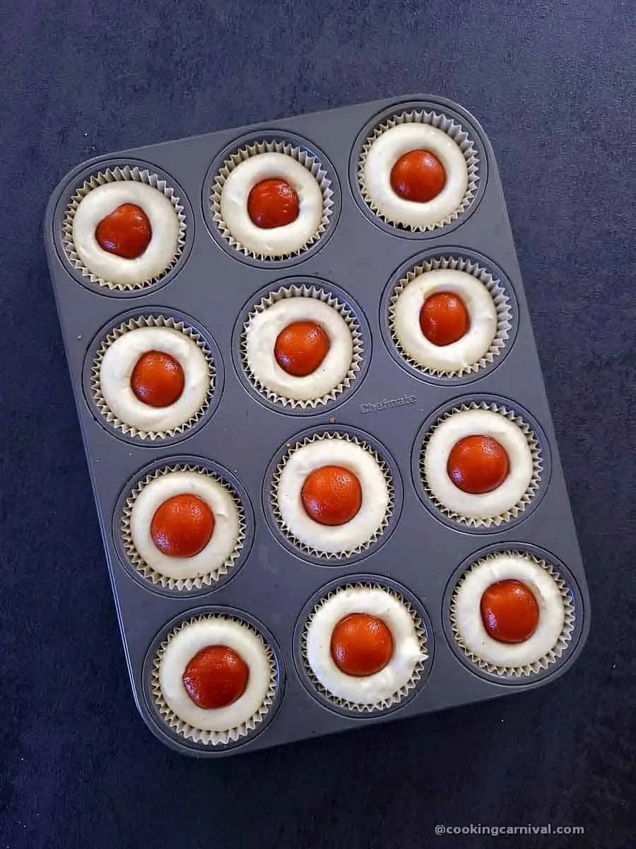 muffin tray filled with Gulab jamun cheesecake