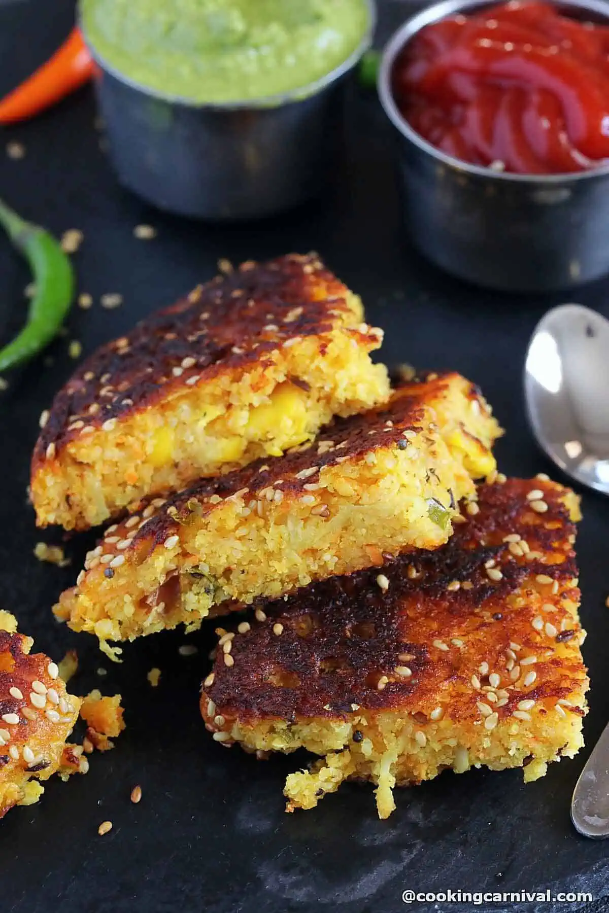 pieces of Gujarati dish handvo on a black tile