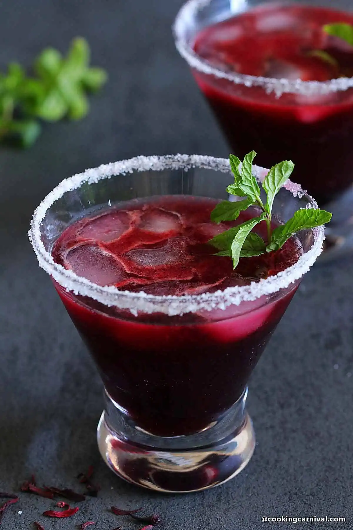 virgin Hibiscus margarita in a glass, garnished with mint leaves.