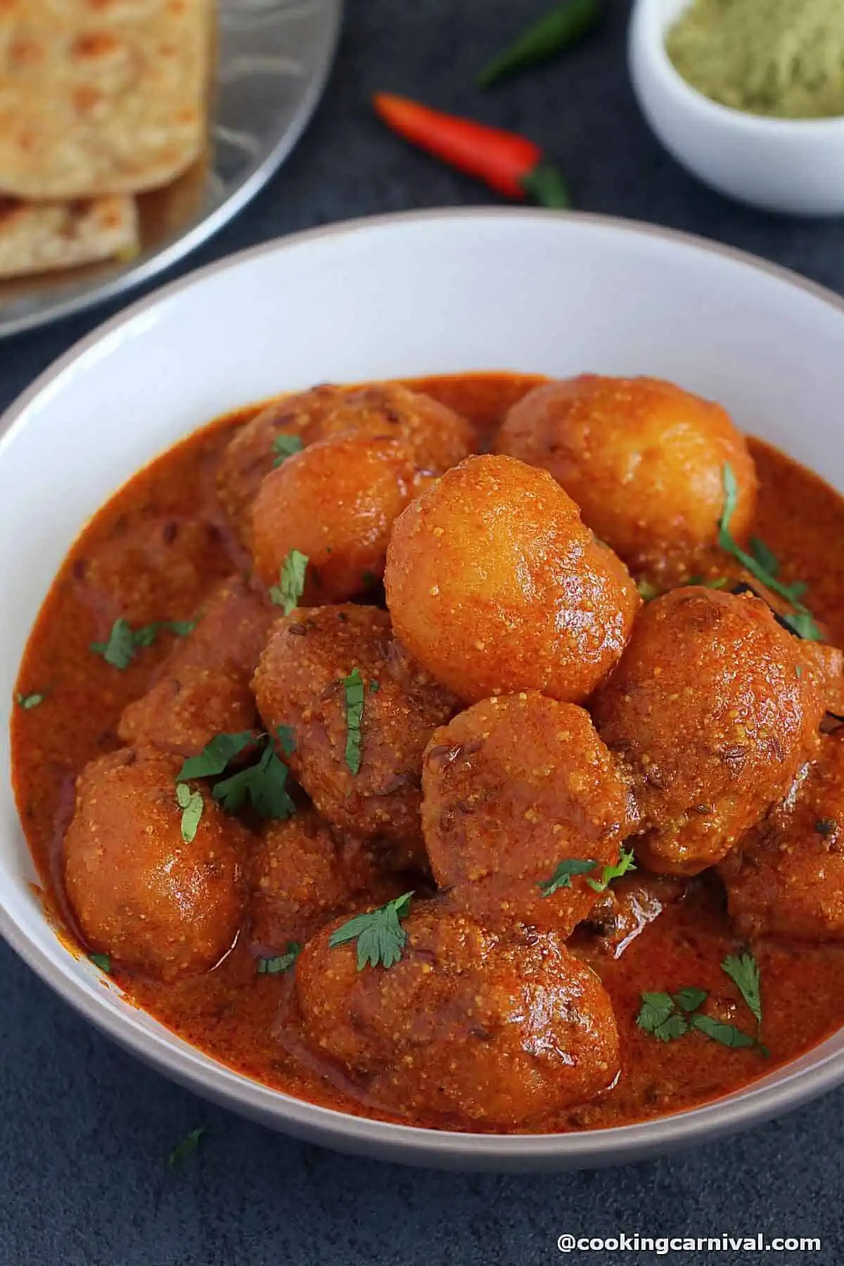 Kashmiri dum aloo served in a white bowl.