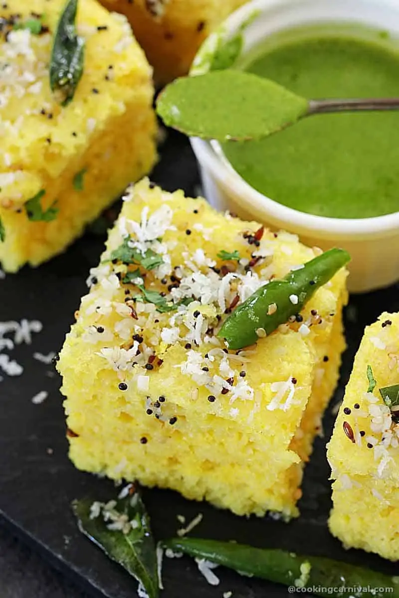 Khaman Dhokla with chutney on a cheese bowrd