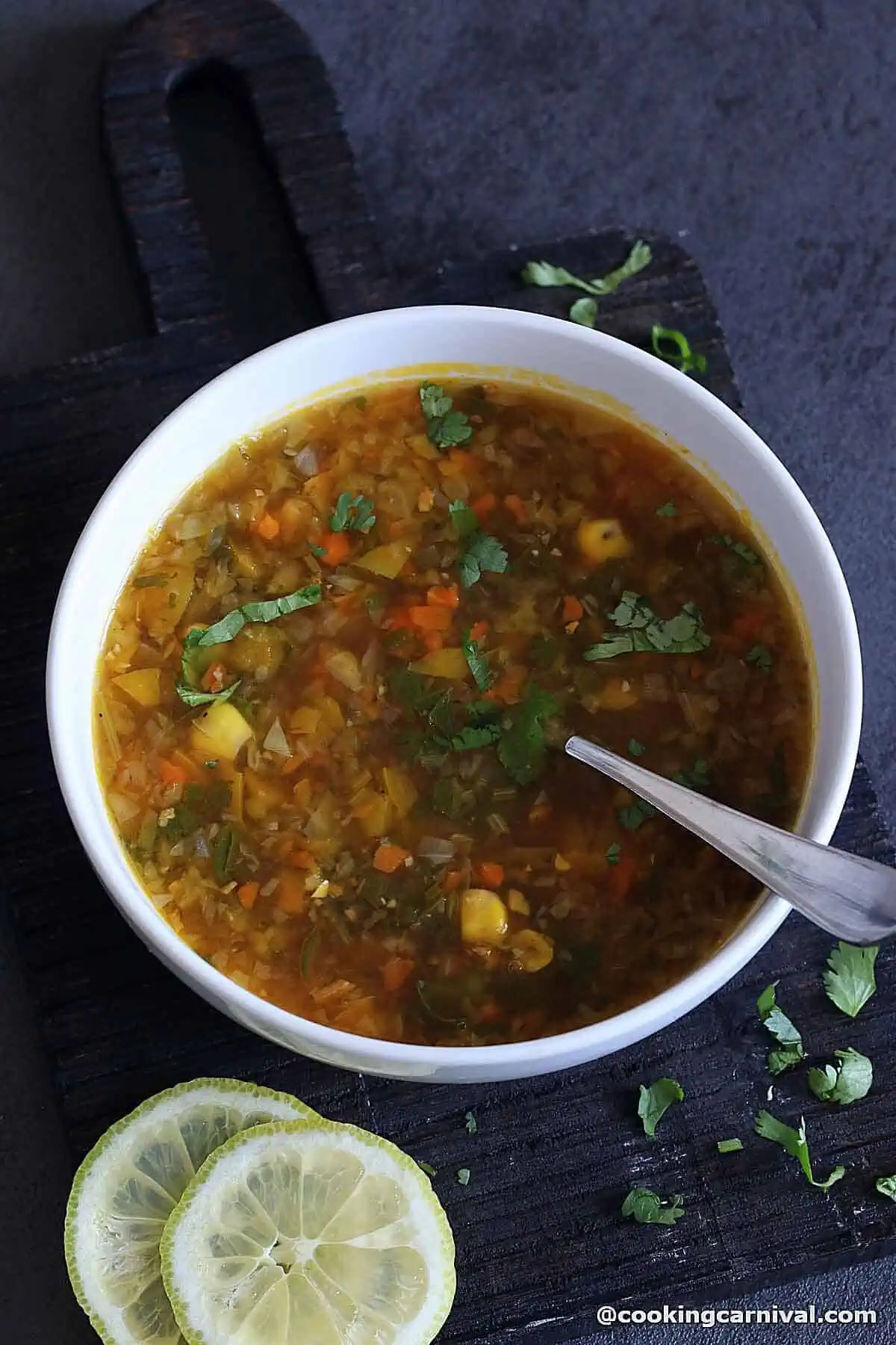 A bowl of Indo-Chinese Soup made with Lemon, Coriander, and vegetables.