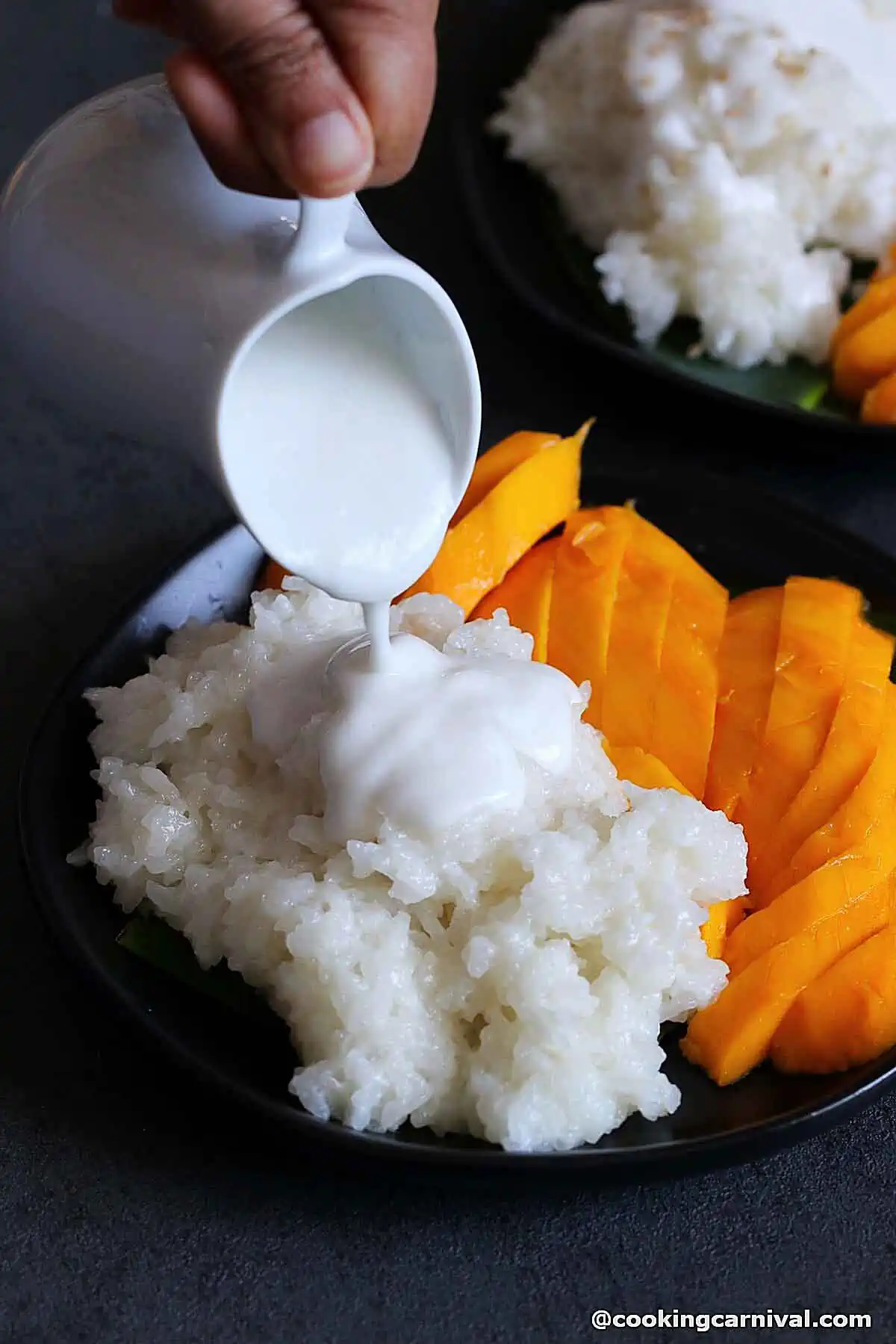 Pouring coconut sauce over sticky rice