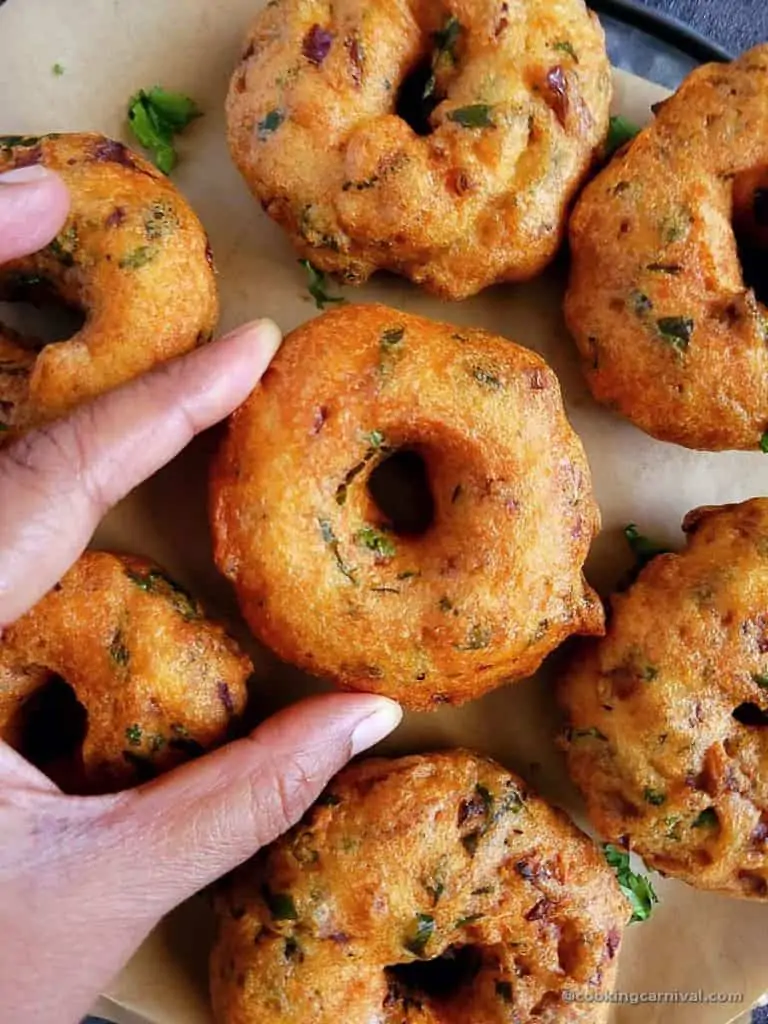 Grabing medu vada with hand