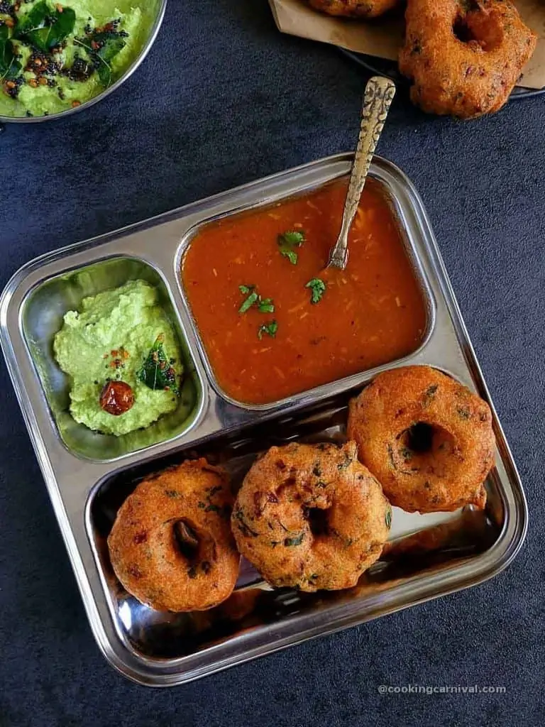 medu vada, chutney and rasam in a plate