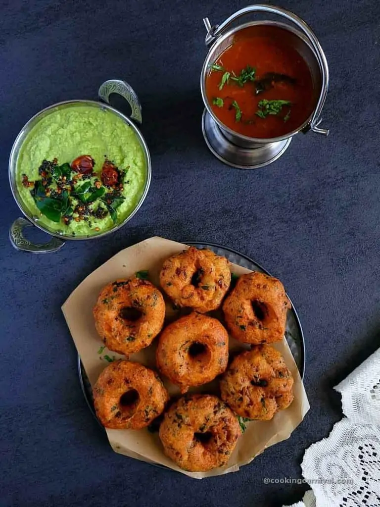 Medu Vada on a plate, coconut chuntye and rasam on side