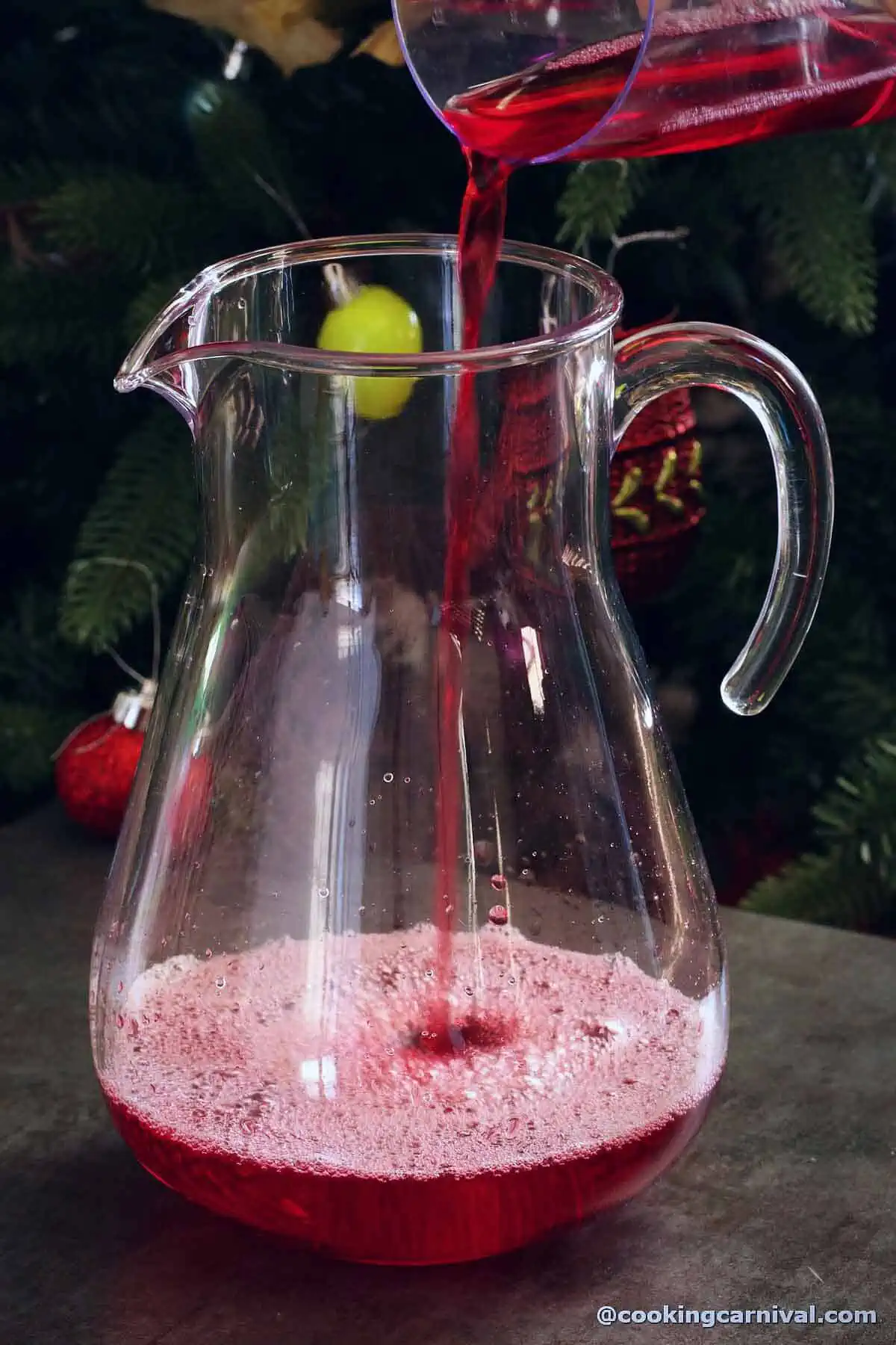 adding cranberry juice in a jug.