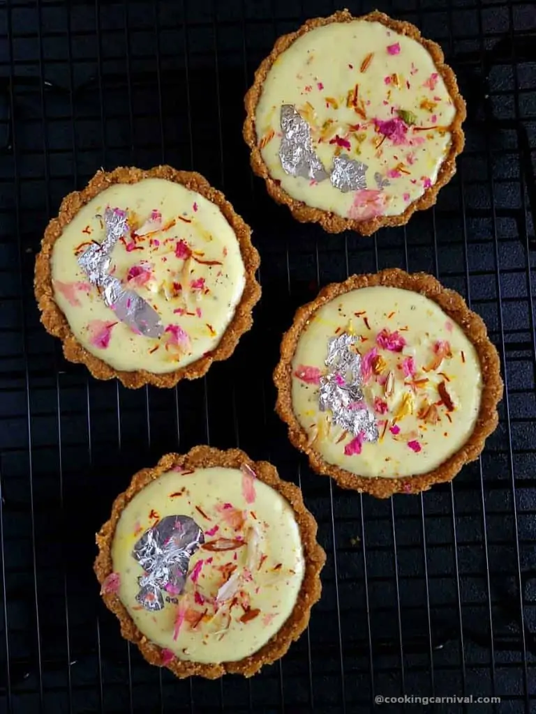 Four No bake shrikhand tart on a wire rack