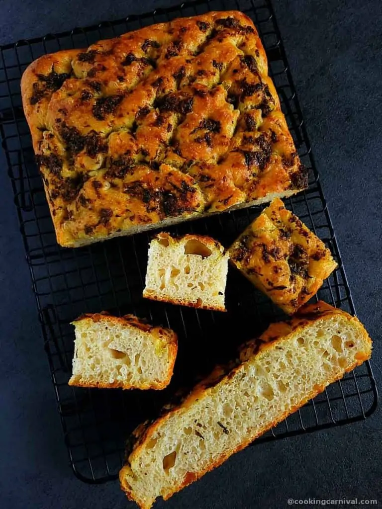 pieces of no knead pesto focaccia bread on gray board