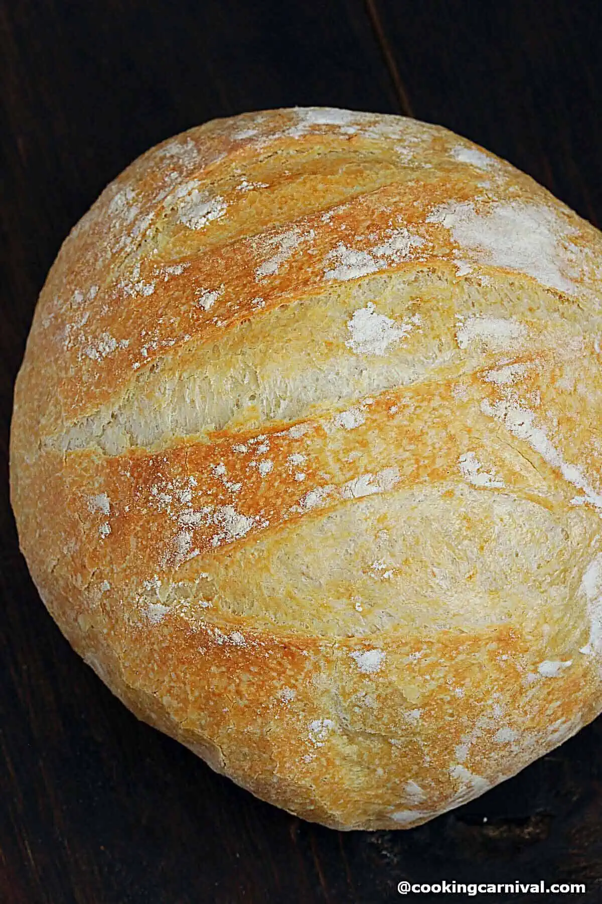 Loaf of No knead bread on a brown board