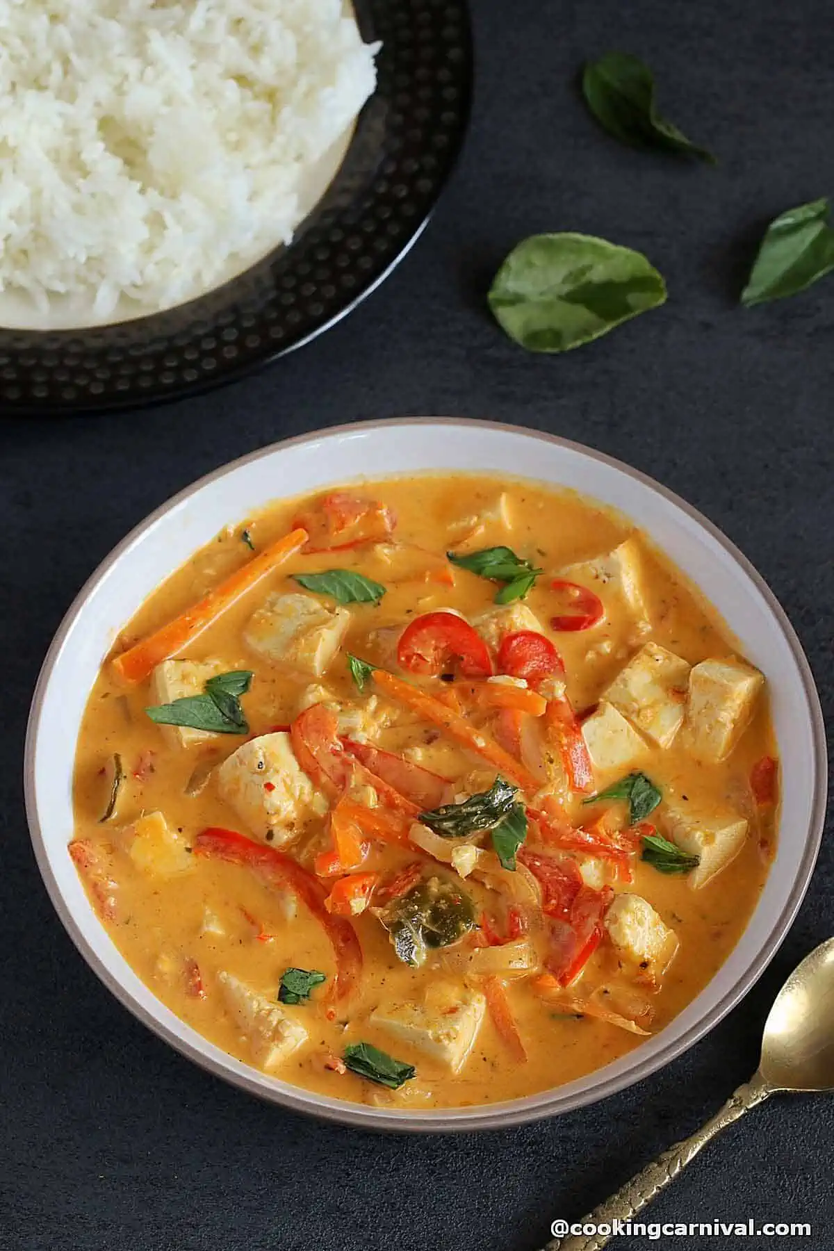 A bowl of panang curry with tofu and vegetables.