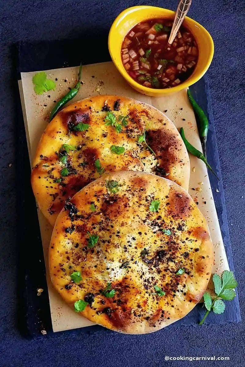 Paneer kulcha with chutney on a black slate