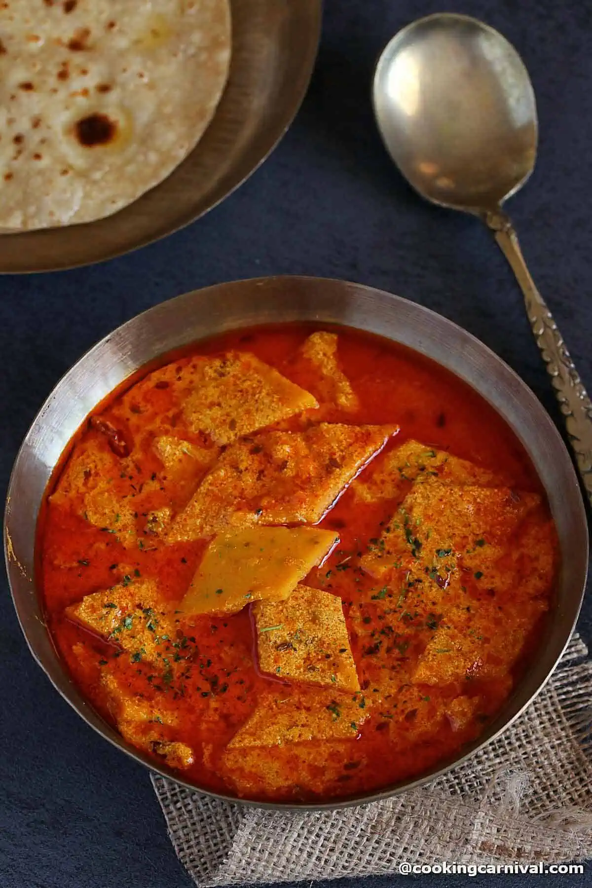 Pitod ki sabji in a kansa bowl, roti on the side.