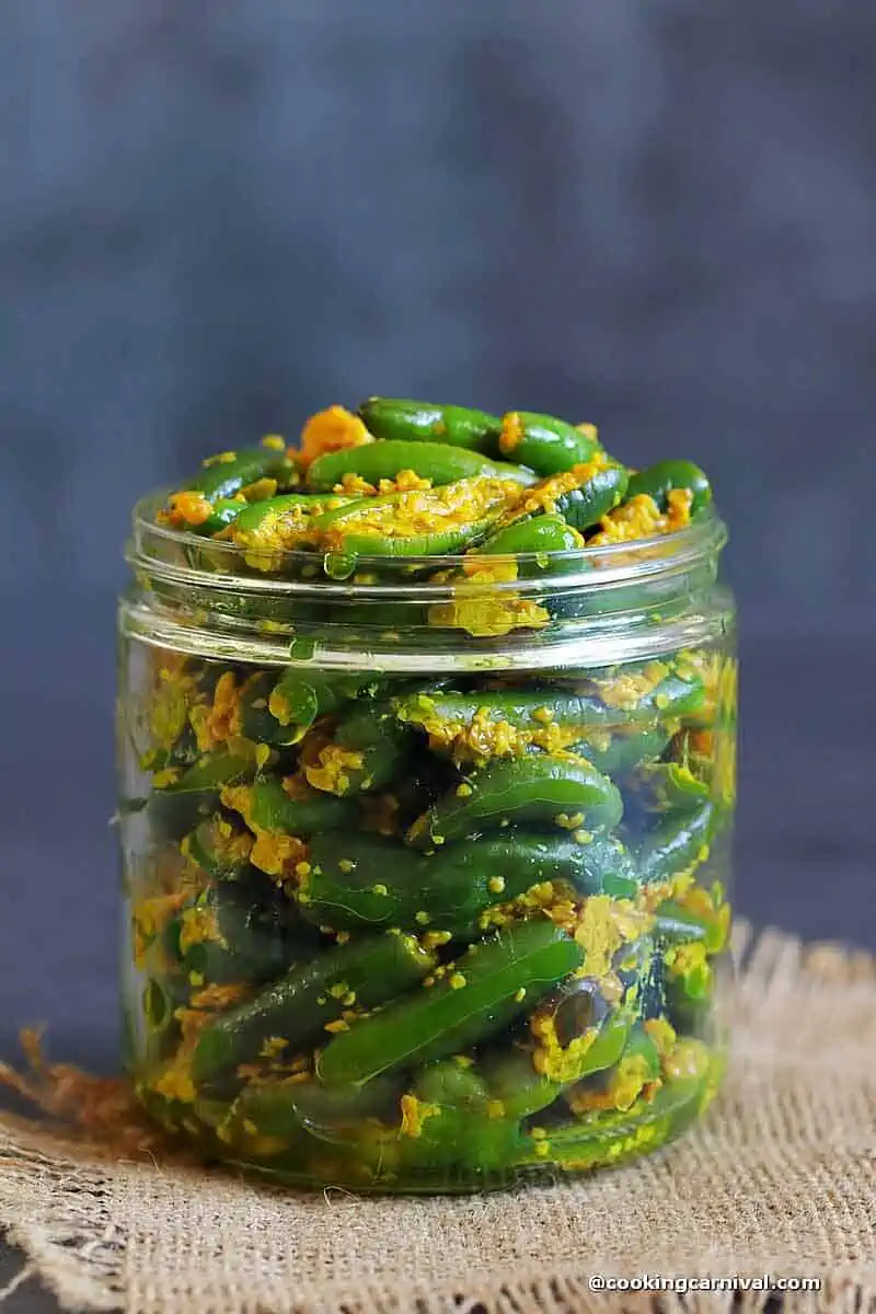 Raita Marcha (Mirchi ka achar) in a glass bottle jar.