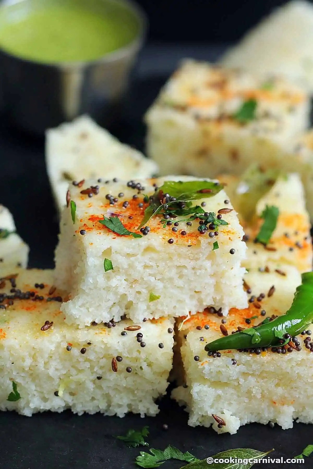 Rava dhokla on a black board.