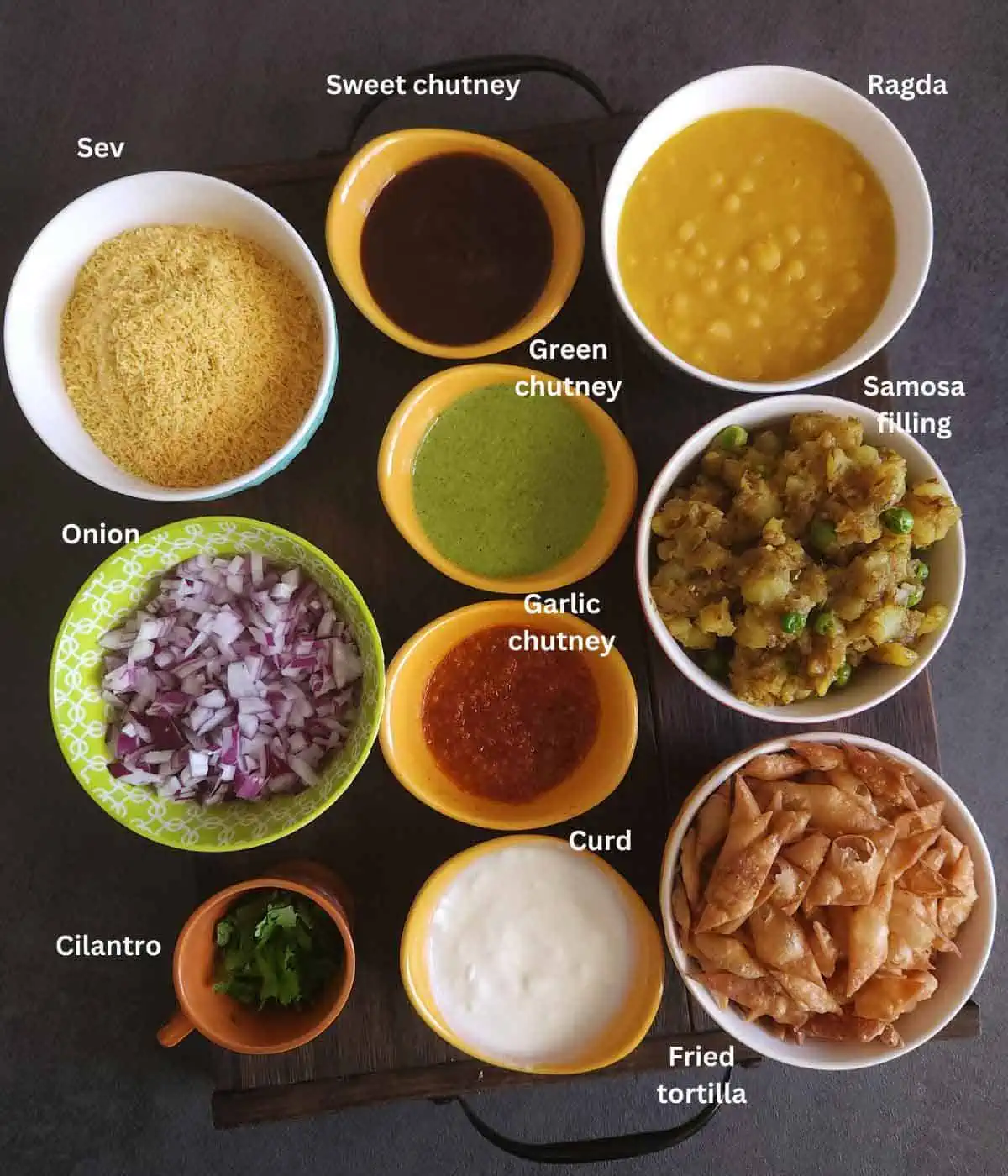 samosa chaat ingredients on a board.