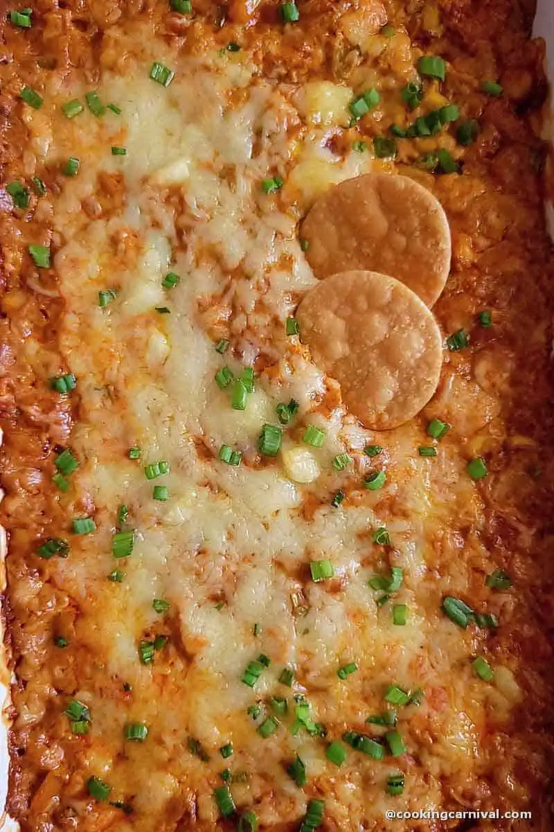 hot corn dip in a baking tray with chips