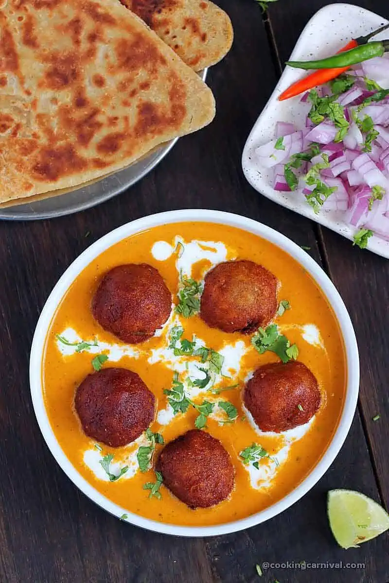 Paneer kofta dunked in shahi tomato onion gravy